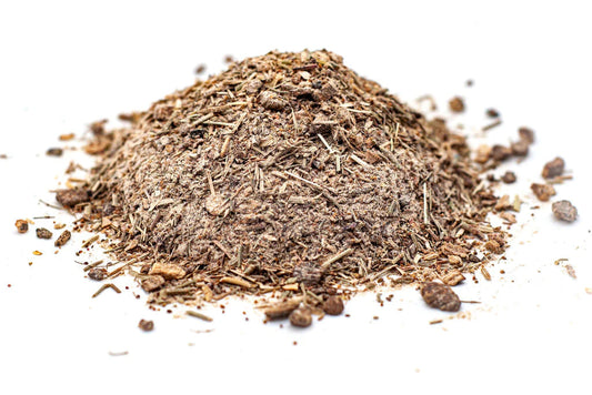 A pile of dried herbal tea ingredients, including burdock root, slippery elm, sheep sorrel, and Indian rhubarb root.